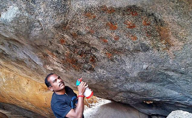Hand print ochre rock art in India