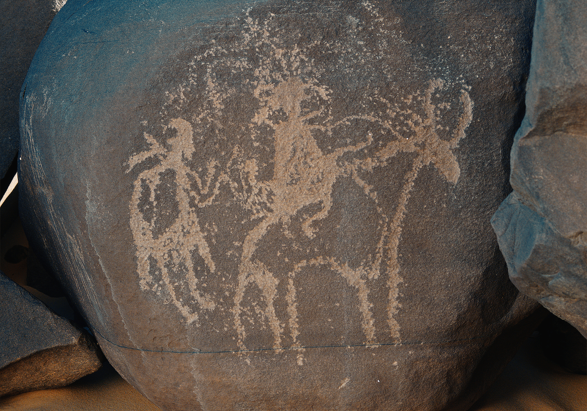 Figures riding cattle at Anakom Niger Africa