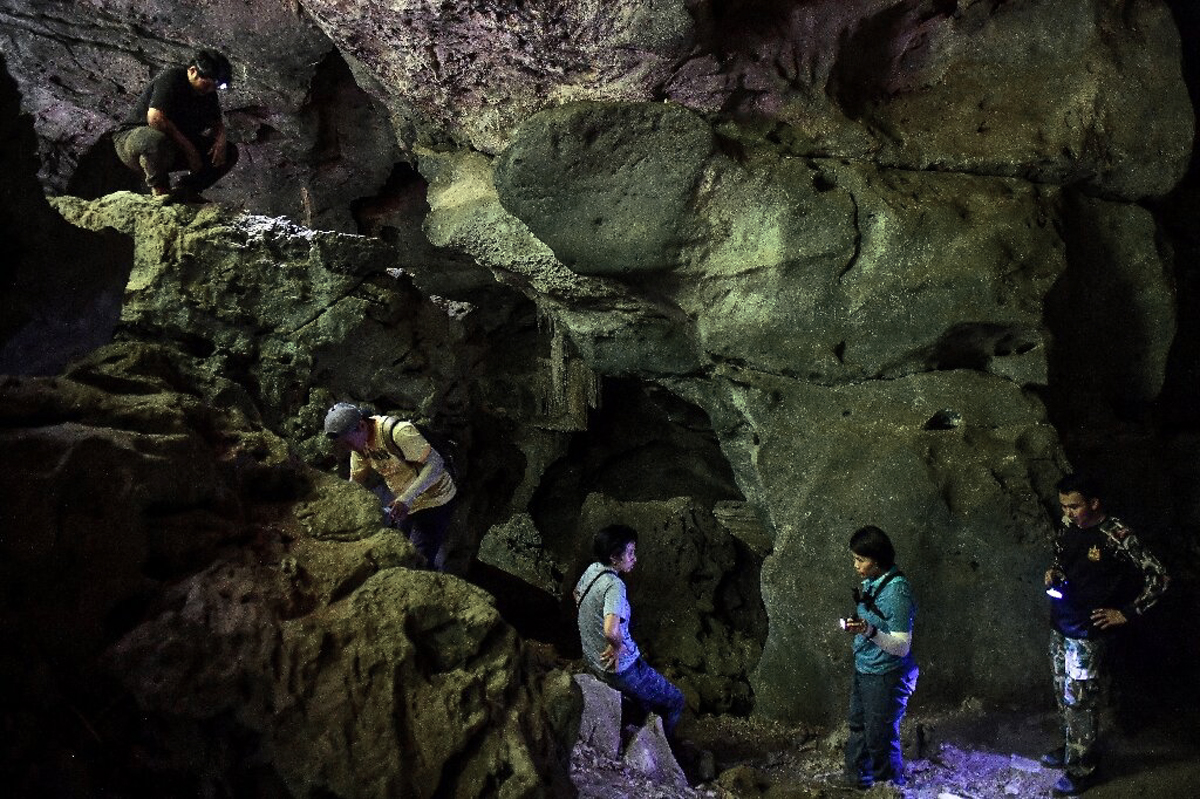 Thai archaeologists hunt ancient artwork cave paintings Thailand