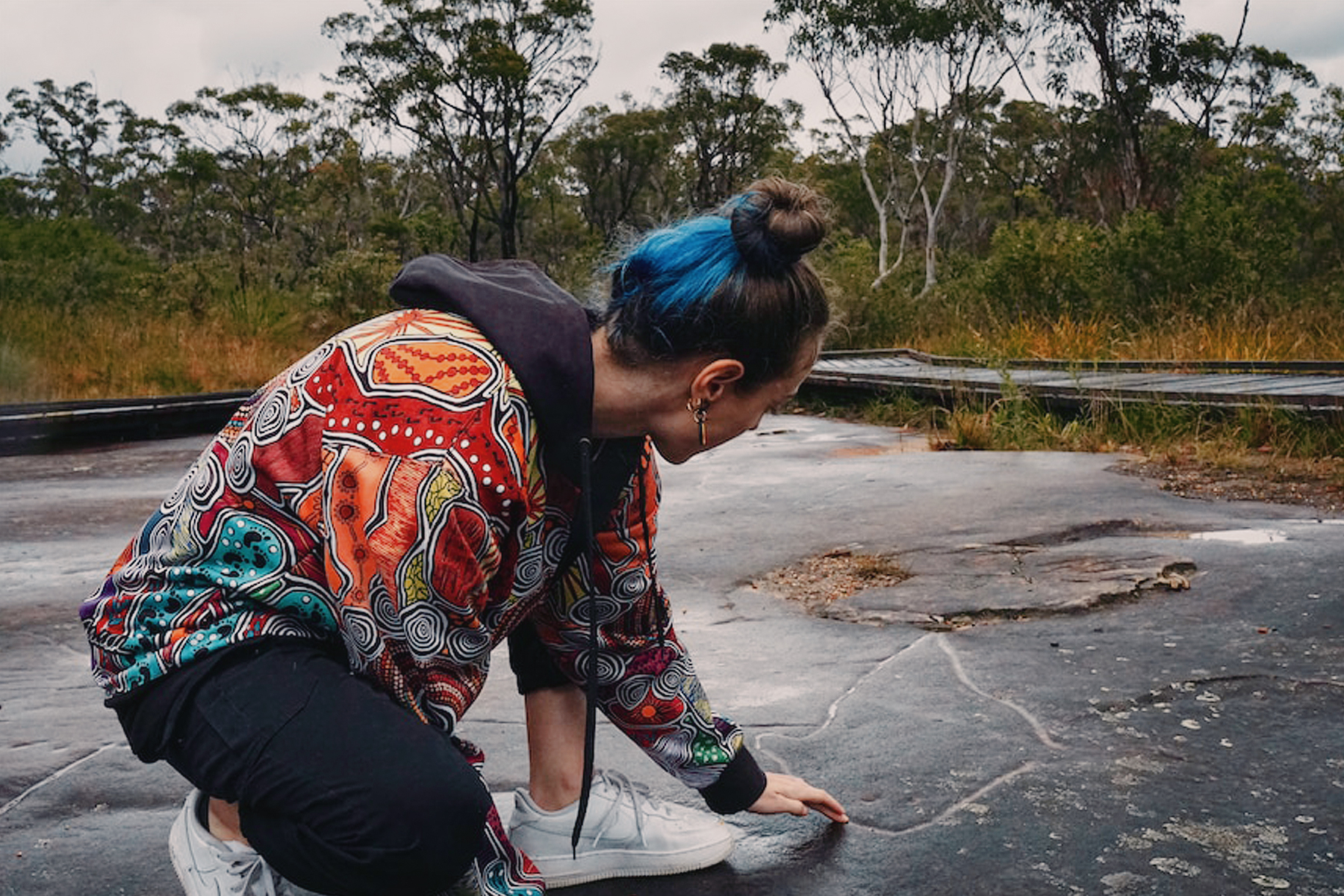 Minmi Gugubarra shows disrupted ancient rock carvings at Bulgandry Aboriginal Art Site